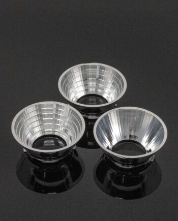 Industrial Spotlight Reflectors. Three silver reflectors of different beam spreads on a gloss black background